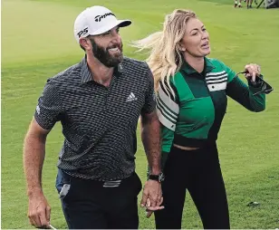  ?? CHRIS CARLSON THE ASSOCIATED PRESS ?? Dustin Johnson walks with Pauline Gretzky after winning the Masters on Sunday in Augusta, Ga.