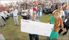  ?? Picture: LULAMILE FENI ?? CASH FOR LAND: Qelana Land Claim Committee chairman Khanyisile Ndzungu, left, proudly displays a cheque of more than R27-million with national Chief Land Claims Commission­er Nomfundo Ntloko-Gobodo at KwaTshemes­e near Mthatha