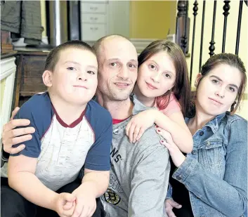  ?? CHERYL CLOCK/STANDARD STAFF ?? Chris Garner, 38, with his three children, eight-year-old Brennan, Jaiden, 11 and Kayla, 15. on Wednesday.