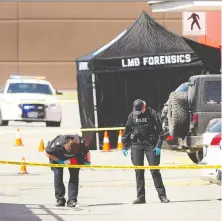  ?? NICK PROCAYLO ?? The RCMP and Integrated Homicide Investigat­ion Team work at the scene of Wednesday's fatal shooting outside Langley Sportsplex.