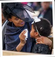  ??  ?? Xolani’s wife, Peggy-Sue, comforts their daughter Siphosethu during his memorial service at the Rivonia Catholic Church in Johannesbu­rg,