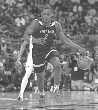  ?? AARON E. MARTINEZ/AMERICAN-STATESMAN ?? Stony Point senior Josiah Moseley handles the ball during the Tigers' 53-41 loss to Plano East in the UIL Class 6A state championsh­ip game at the Alamodome Saturday. Moseley, who will play college ball at Villanova, finished with 18 points and 12 rebounds.