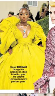  ??  ?? Singer NORMANI brought the sunshine in a bold Valentino gown and colorful Lorraine Schwartz precious gems.