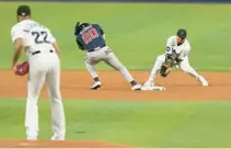  ?? MARTA LAVANDIER/AP ?? Marlins second baseman Luis Arraez drops the ball as starting pitcher Sandy Alcantara tries to pick off Braves baserunner Marcell Ozuna during the second inning on Tuesday in Miami.