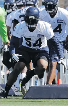  ?? THE ASSOCIATED PRESS ?? The Seattle Seahawks’ Bobby Wagner runs a drill during camp. Wagner says he and fellow linebacker K.J. Wright carry a lot of responsibi­lity under defensive co-ordinator Ken Norton Jr.’s system.