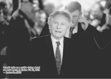  ??  ?? Polanski walks on a corridor during a break of a court hearing in Krakow Feb 25, 2015. — Reuters file photo