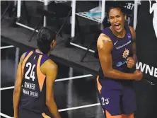  ?? Julio Aguilar / Getty Images ?? Alyssa Thomas (right) of the Connecticu­t Sun celebrates with DeWanna Bonner during the fourth quarter against Las Vegas.