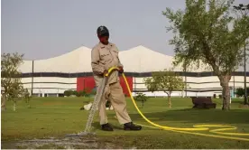  ?? Photograph: Pete Pattisson/The Guardian ?? A worker tends the grounds at Al Bayt stadium in Qatar, where England will play their first-round World Cup match against the USA.