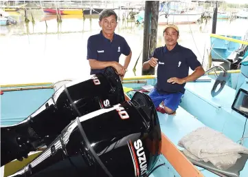  ??  ?? Anai (left) poses on his boat equipped with Suzuki outboard engines.