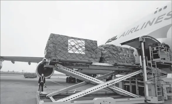  ?? HUANG ZONGZHI / XINHUA ?? Above: Chinese medical supplies are loaded for shipment to Belgium at Hangzhou Internatio­nal Airport in Zhejiang province in March.