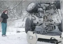  ?? CHRISTOPHE­R MILLETTE/THE ASSOCIATED PRESS ?? Media coverage of winter storms often includes images of overturned SUVs.