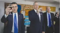  ?? (Olivier Fitoussi/Flash90) ?? JUSTICE MINISTER Gideon Sa’ar and Defense Minister Benny Gantz raise a toast during a changeover ceremony at the Justice Ministry in Jerusalem earlier this month.