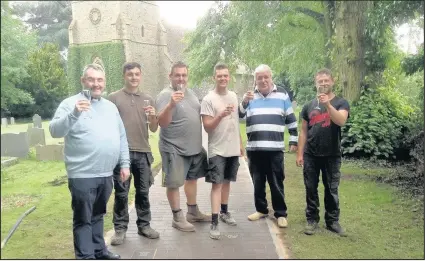  ??  ?? Churchward­en Robin Wilson, second from right, raises a toast to his late wife, church treasurer Lyn Wilson with, left, the Rev Andrew Hall, Rector of Burbage and Aston Flamville, and a team from Countestho­rpe-based Ultimate Landscapes Ltd who carried...