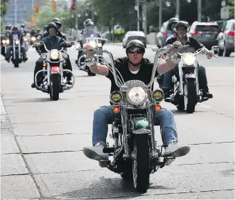  ?? PHOTOS: DAN JANISSE ?? Bikers rolled down Riverside Drive Sunday on a route that took them through downtown and parts of the county. In the past decade, the ride has raised over $600,000.