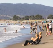  ?? Jessica Christian / The Chronicle ?? Stinson Beach is a popular place to cool off. August and September were their hottest ever this year in California, and October might be also.