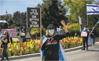  ?? Ariel Schalit / Associated Press ?? Israelis protesting Benjamin Netanyahu serving as prime minister while facing criminal indictment­s seem to be setting a new standard for public protests in the virusera in Jerusalem.