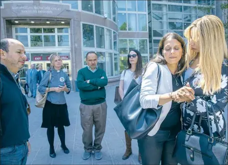  ?? NANCY ISKANDER, Mel Melcon Los Angeles Times ?? second from right, is consoled by a friend outside Van Nuys Courthouse during a break from a preliminar­y hearing for Rebecca Grossman, who is charged with murder stemming from the Westlake Village crash. At far left is Iskander’s husband, Karim.