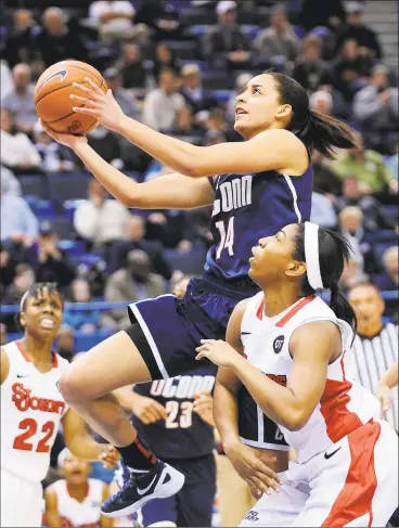  ?? Fred Beckham / Associated Press ?? UConn’s Bria Hartley drives past St. John’s Nadirah McKenith in a 2012 Big East tournament semifinal. Hartley, now with the WNBA’s Phoenix Mercury, brought her 3-year-old son, Bryson, to Florida with her. “I was just overseas, and my son didn’t go with me,” she said. “I wasn’t going to go another three months in the bubble where he wasn’t with me.”