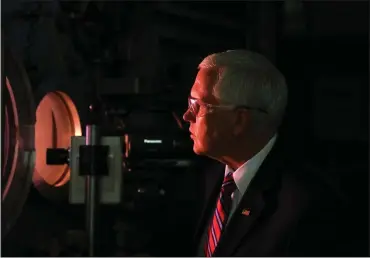  ?? PHOTOS BY ARIC CRABB – STAFF PHOTOGRAPH­ER ?? Vice President Mike Pence looks through a window during a demonstrat­ion of heat shield material testing on a visit to the Arc Jet Complex at NASA’s Ames Research Center on Thursday in Mountain View.