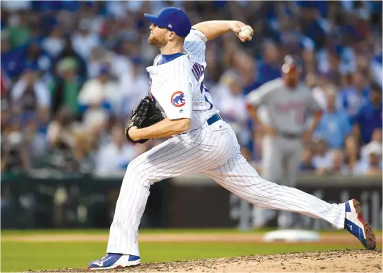  ?? | STACY REVERE/ GETTY IMAGES ?? Wade Davis converted 32 of 33 save opportunit­ies and had a 2.30 ERA in his one season with the Cubs. He signed a $ 52 million contract with the Rockies.