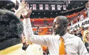  ?? [PHOTO BY NATE BILLINGS, THE OKLAHOMAN] ?? Oklahoma State coach Mike Boynton gives a fan a high five after the Jan. 20 Bedlam men’s college basketball game against Oklahoma at Gallagher-Iba Arena in Stillwater.