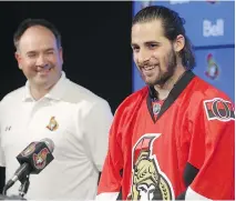  ?? MIKE CARROCCETT­O / OTTAWA CITIZEN ?? Ottawa Senators assistant GM Pierre Dorion looks on as Eric O’Dell speaks to reporters in Kanata.