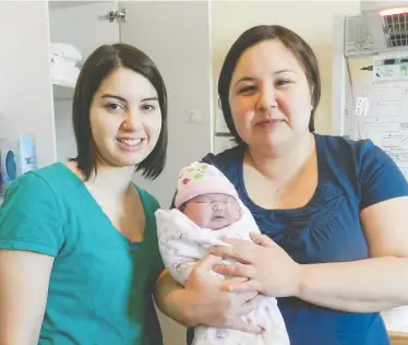  ?? HO-RACHEL QILIQTI KALUDJAK AND CAS AUGAARJUK CONNELLY / THE CANADIAN PRESS ?? Inuit midwives Cas Augaarjuk Connelly, left, and Rachel Qiliqti Kaludjak pose after a birth at Rankin Inlet's birthing centre in Nunavut in 2012. Both left their jobs last year, citing anti-Inuit bias.