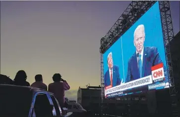  ?? Jeff Chiu Associated Press ?? AT A DRIVE- I N watch party in San Francisco, voters take in last week’s debate between President Trump and Joe Biden. Trump says a Biden victory will crash the stock market — a problemati­c claim on several levels.