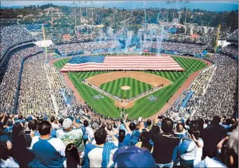  ?? Photog raphs by Christina House For The Times ?? PHOTOGENIC Dodger Stadium’s $100-million-plus face-lift makes an impression with the crowd of 53,138, even if some fans were frustrated that the issue of long concession lines remained unresolved.