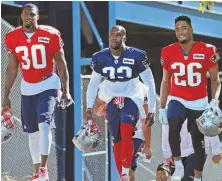  ?? STAFF PHOTO BY MATT WEST ?? THEY’RE BACK: Defensive backs Duron Harmon (left), Devin McCourty and Logan Ryan hit the field for yesterday’s training camp session in Foxboro.