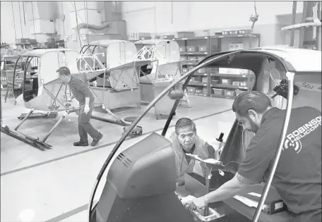  ?? Photograph­s by Christina House Los Angeles Times ?? WORKERS at Robinson Helicopter Co. in Torrance. In 2014, the Federal Aviation Administra­tion concluded that the R44 model was statistica­lly no more prone to fatal post-crash fires than other helicopter­s designed and certified by the government before 1994.