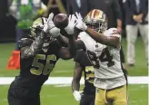  ?? Chris Graythen / Getty Images ?? The 49ers’ Kendrick Bourne and Demario Davis of the Saints go after the ball. Bourne had four receptions for 26 yards.