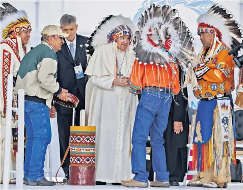  ?? ?? Pope Francis wears a traditiona­l headdress presented to him by tribal chiefs in Maskwacis, Canada, after he apologised for the ‘deplorable evil’ of abuse in residentia­l schools