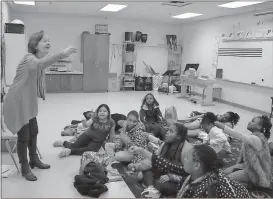  ??  ?? ABOVE: Local storytelle­r Jane Cunningham sings “The Bubblegum Song” to the students at North Heights Elementary.