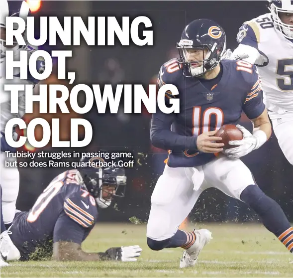  ?? JOE ROBBINS/GETTY IMAGES ?? Bears quarterbac­k Mitch Trubisky runs for a first down ahead of Samson Ebukam of the Los Angeles Rams in the first quarter at Soldier Field.