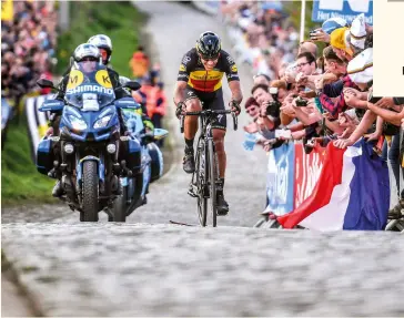  ?? ?? Philippe Gilbert powers up the Oude Kwaremont on the way to victory in the 2017 Tour of Flanders.