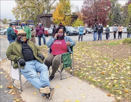  ?? Photos by James Franco / Special to the Times Union ?? Expecting a long wait, Will and Shawna Clark brought chairs to use in the line to vote at the Pine Grove Methodist Church on Central Avenue in Colonie during the first day of early voting in New York state on Saturday.