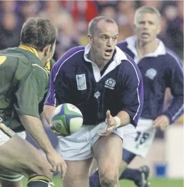  ?? ?? Scotland No 10 Gregor Townsend breaks through the South African defence at a World Cup match at Murrayfiel­d in October 1999