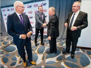  ?? @IMartensHe­rald Herald photo by Ian Martens ?? Western Hockey League commission­er Ron Robison, second for right, congratula­tes Kelowna bid committee chair Tom Dyas, alongside Rockets’ owner Bruce Hamilton, left, and vice-president Gavin Hamilton, right, following the announceme­nt Wednesday in Calgary awarding them the 2020 Memorial Cup over Lethbridge and Kamloops.