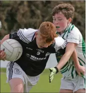  ??  ?? Ryan Gavin of St. Joseph’s is tackled by Adam Murphy (Crossabeg-Ballymurn).