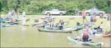  ?? Keith Bryant/The Weekly Vista ?? A crowd gathers near the edge of Lake Avalon to try out a variety of kayaks and watch friends and family on the water during Saturday’s demo day.