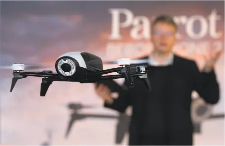  ?? Paul Chinn / The Chronicle ?? Parrot CEO Henri Seydoux demonstrat­es his company’s Bebop Drone 2, basically a video camcorder with four propellers.
