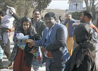  ?? Banaras Khan/AFP/Getty Images ?? Pakistani Christians are evacuated by security personnel from a Methodist church after a suicide-bomber attack during a Sunday service on Dec. 17 in Quetta.