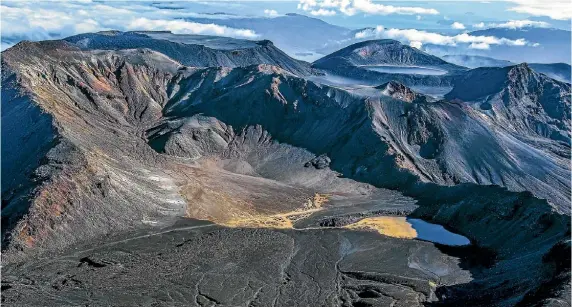  ?? PHOTOS: TIM BREWSTER ?? The Tongariro Crossing’s volcanic rock makes it look like a moonscape.