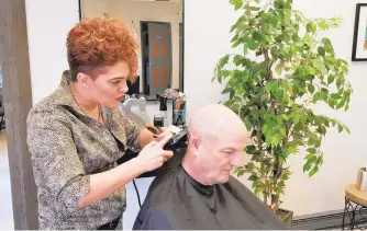  ?? RYAN KNELLER/THE MORNING CALL ?? Honor Family Hair Care owner Shannon Guarino cuts Palmer Township resident Joe Tita’s hair in her newly opened salon at 1424 Pennsylvan­ia Ave. in Allentown.