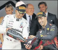  ?? REUTERS ?? Red Bull’s Daniel Ricciardo, winner of Monaco GP, with thirdplace­d Lewis Hamilton.