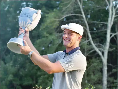  ?? — USA Today Sports ?? USA’S Bryson Dechambeau celebrates with the trophy after winning the Dell Technologi­es Championsh­ip at TPC of Boston.