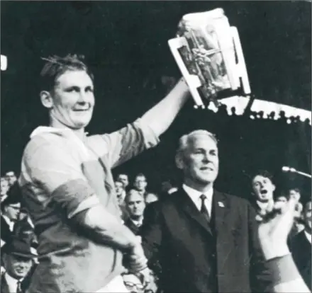  ??  ?? Dan Quigley receiving the Liam MacCarthy Cup from G.A.A. President Seamus O Riain, himself a native of Tipperary.