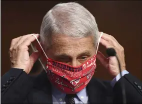  ?? KEVIN DIETSCH — THE ASSOCIATED PRESS ?? Dr. Anthony Fauci, director of the National Institute for Allergy and Infectious Diseases, lowers his face mask as he prepares to testify before a Senate Health, Education, Labor and Pensions Committee hearing on Capitol Hill in Washington, Tuesday, June 30.