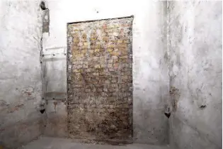  ??  ?? Above: Pairs of iron pintles in the corners would have supported two great doors into Westminste­r Hall; left of the 1851 brick blocking is a sheet of glass fixed by Scott to protect Victorian graffiti